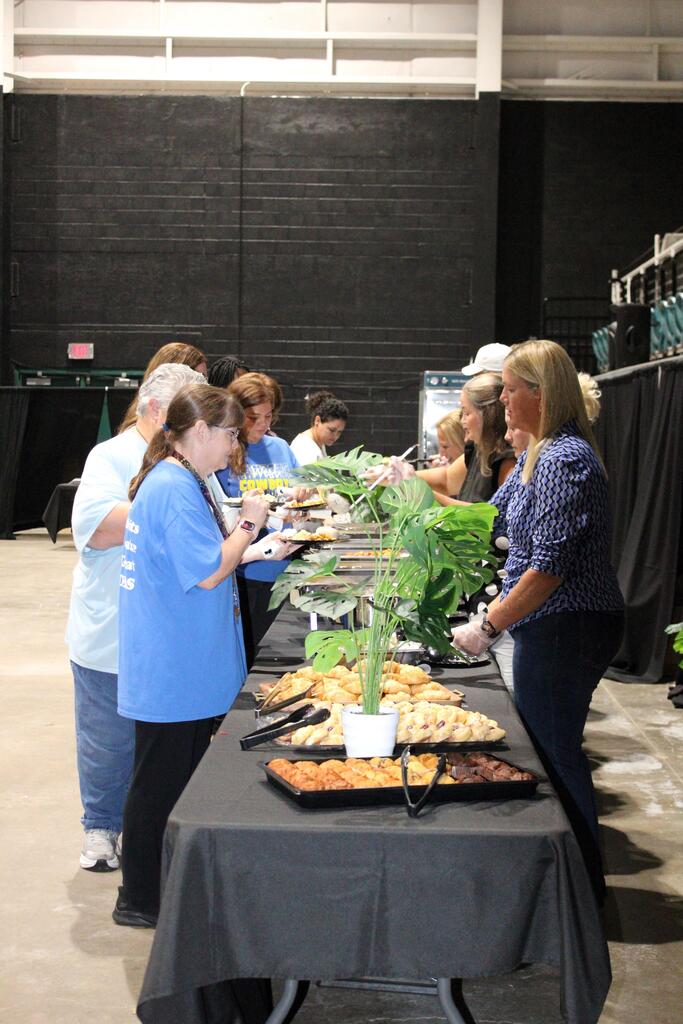 staff serving breakfast to other staff