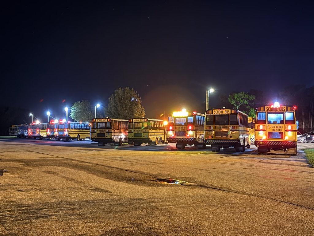 busses in parking lot preparing to take off