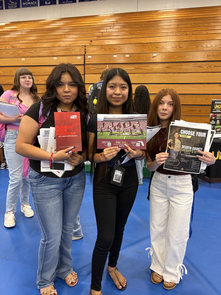 student engaging with college reps at a college day in the DHS gym