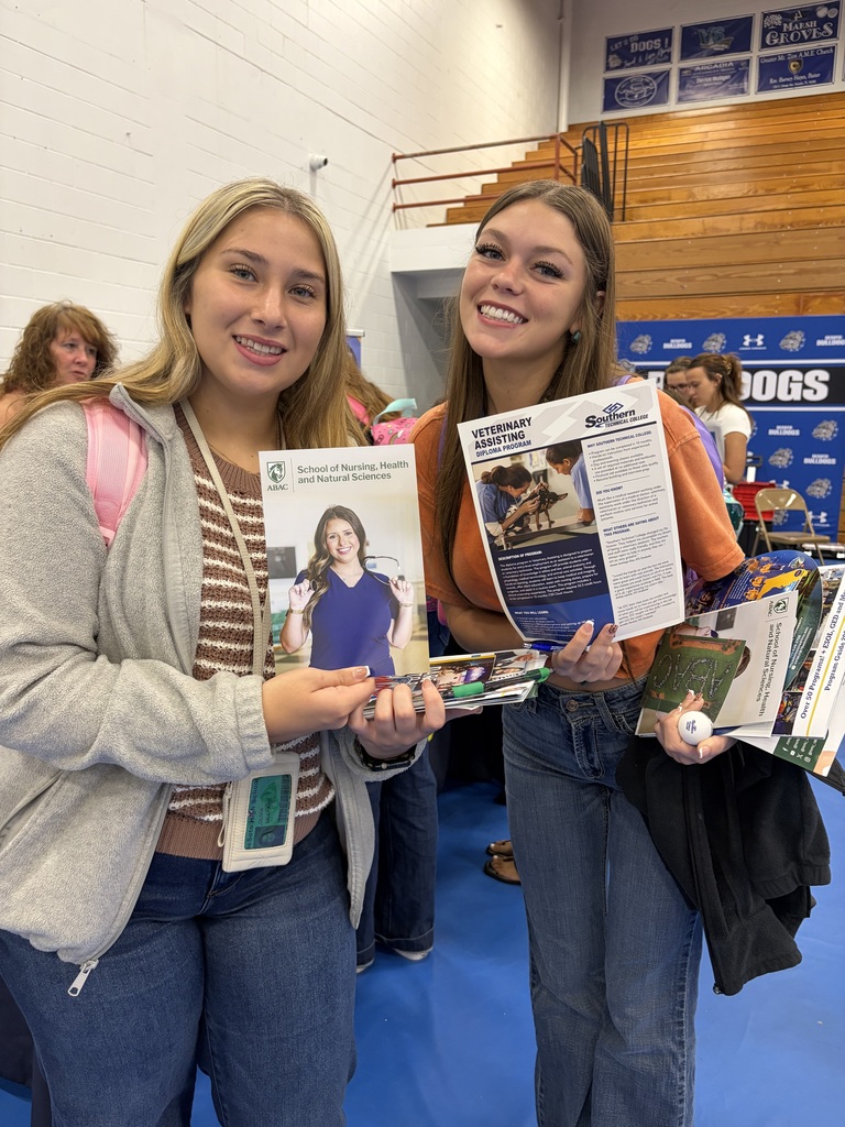 student engaging with college reps at a college day in the DHS gym