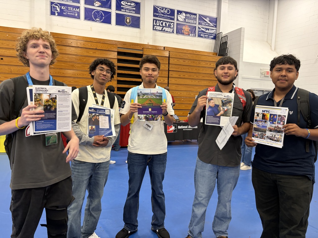 student engaging with college reps at a college day in the DHS gym