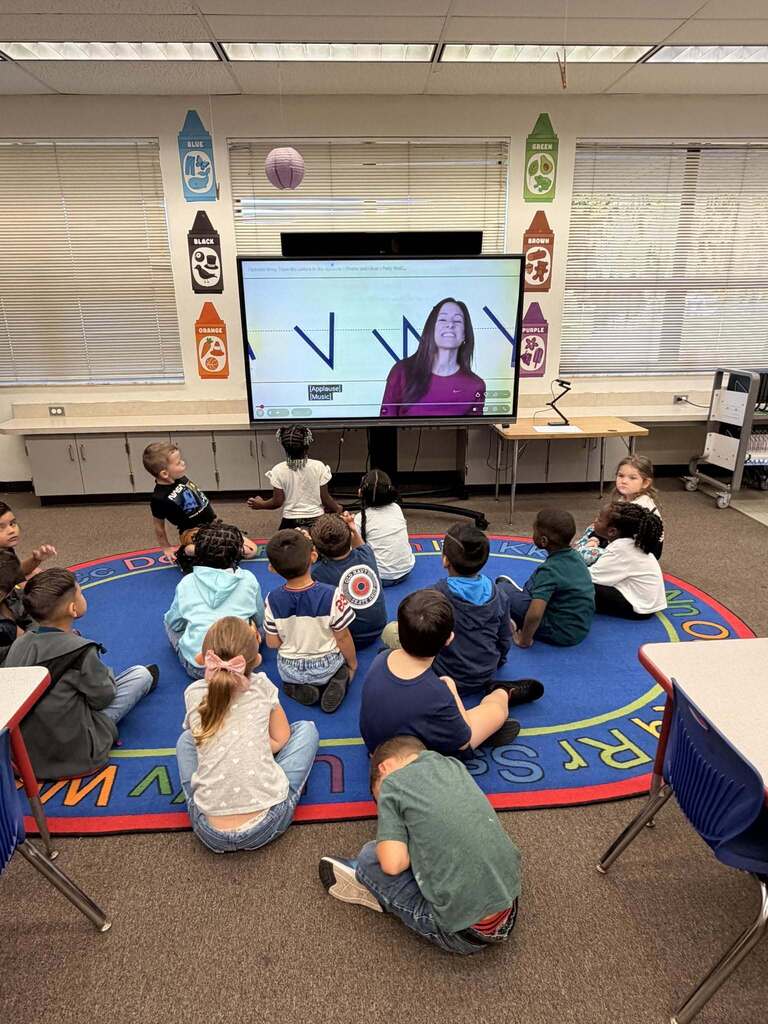 student watching a learning video in class