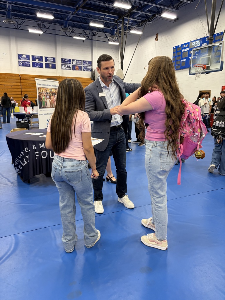 two students talking to college recruiter