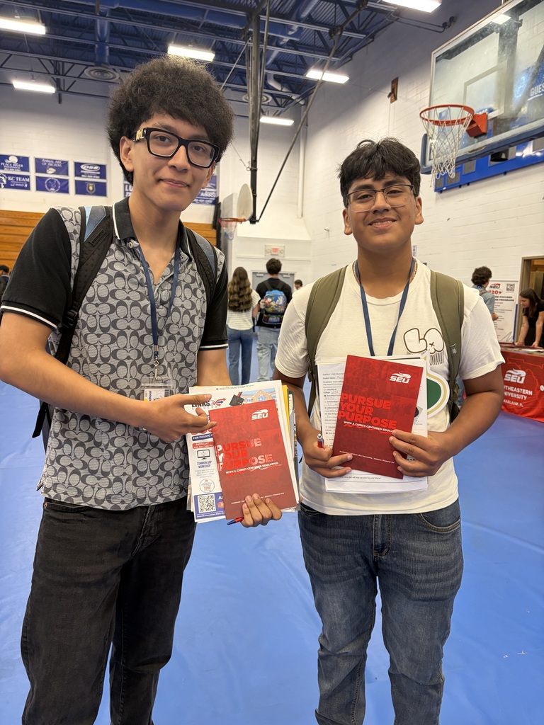 two student posing for a picture at college day