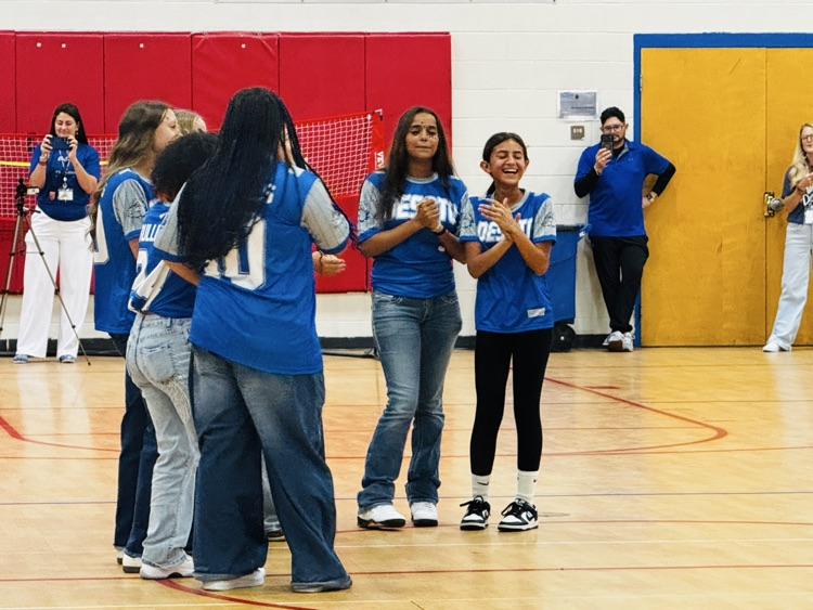 softball team standing on the basketball court