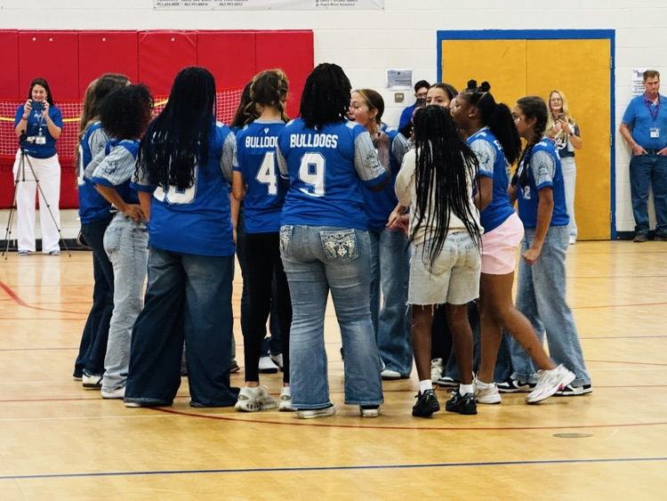 cross country team standing in the basketball court