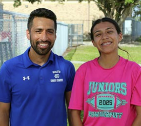 coach and student posing at cross country meet