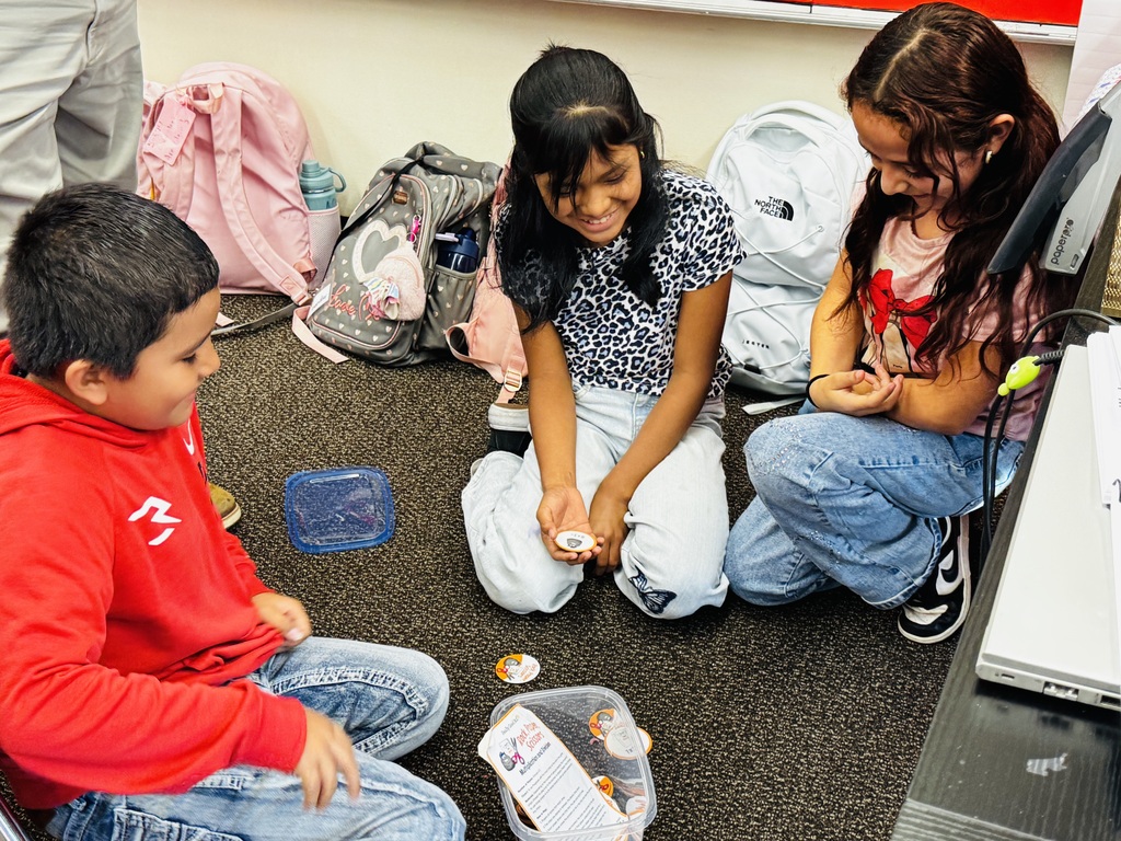 3 students completing an activity in small group
