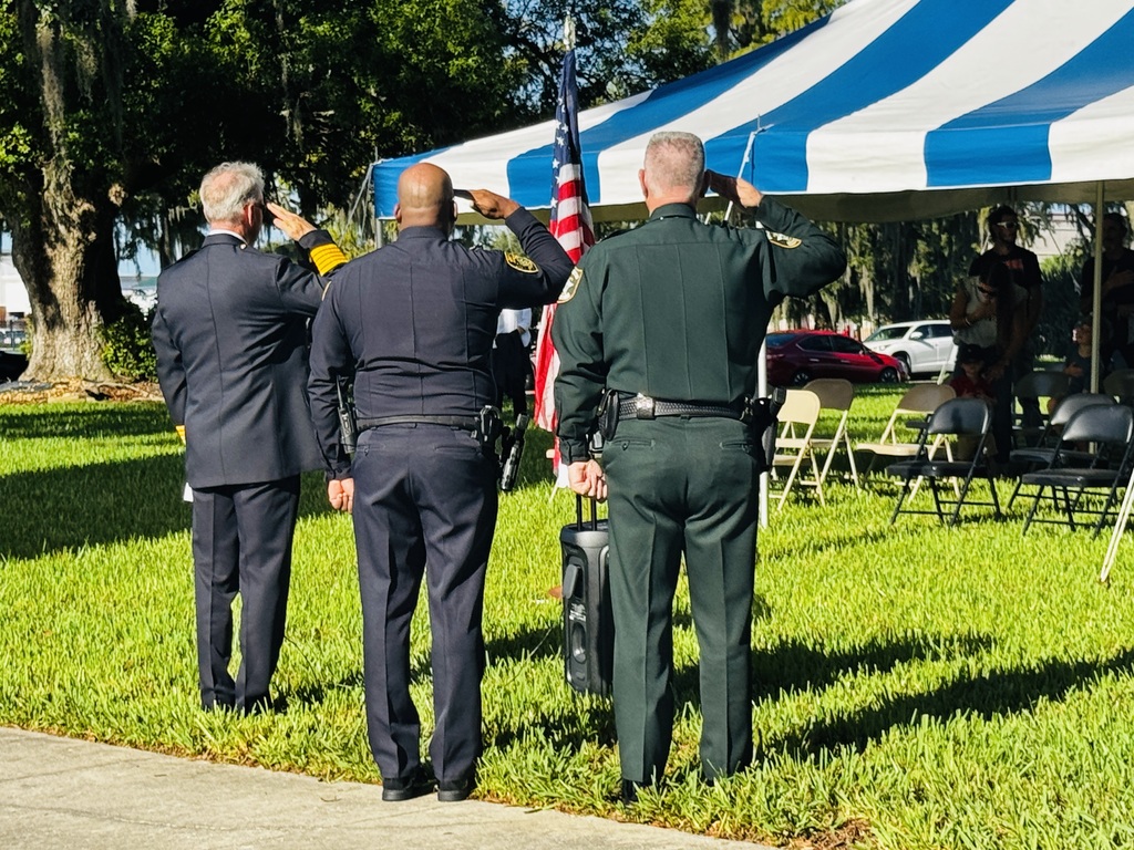 officers soluting the flag