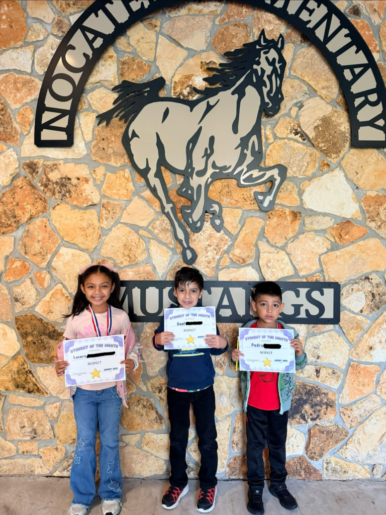 three students holding certificates and smiling for a picture