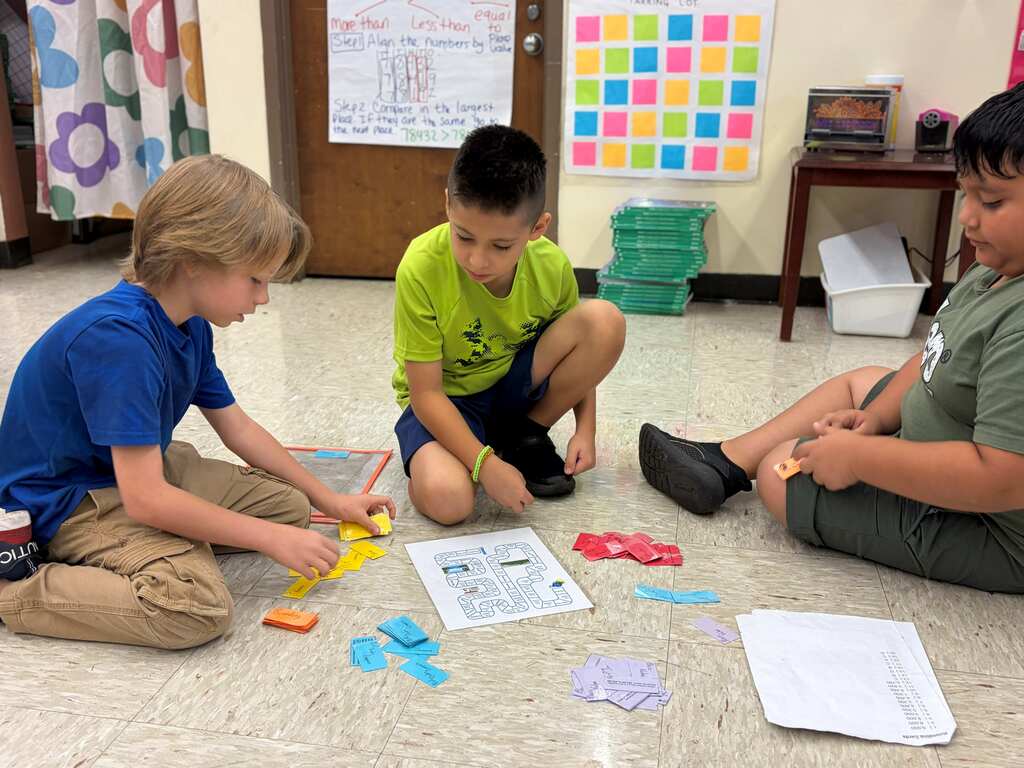 three students doing group work