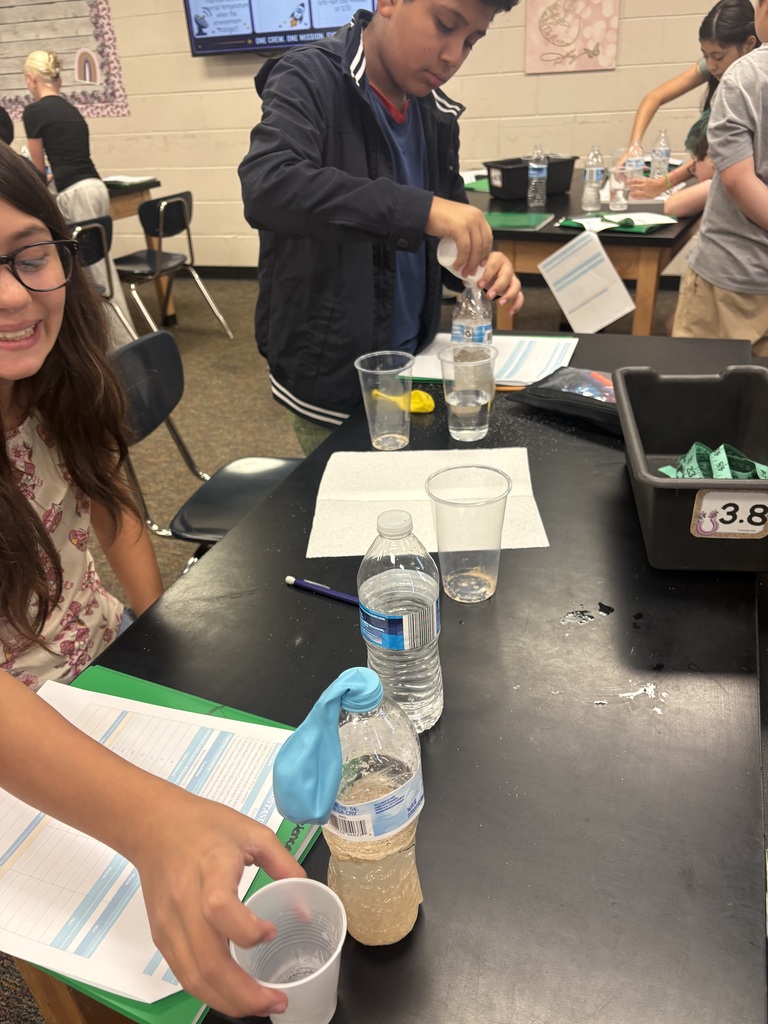 students conducting a science experiment in class