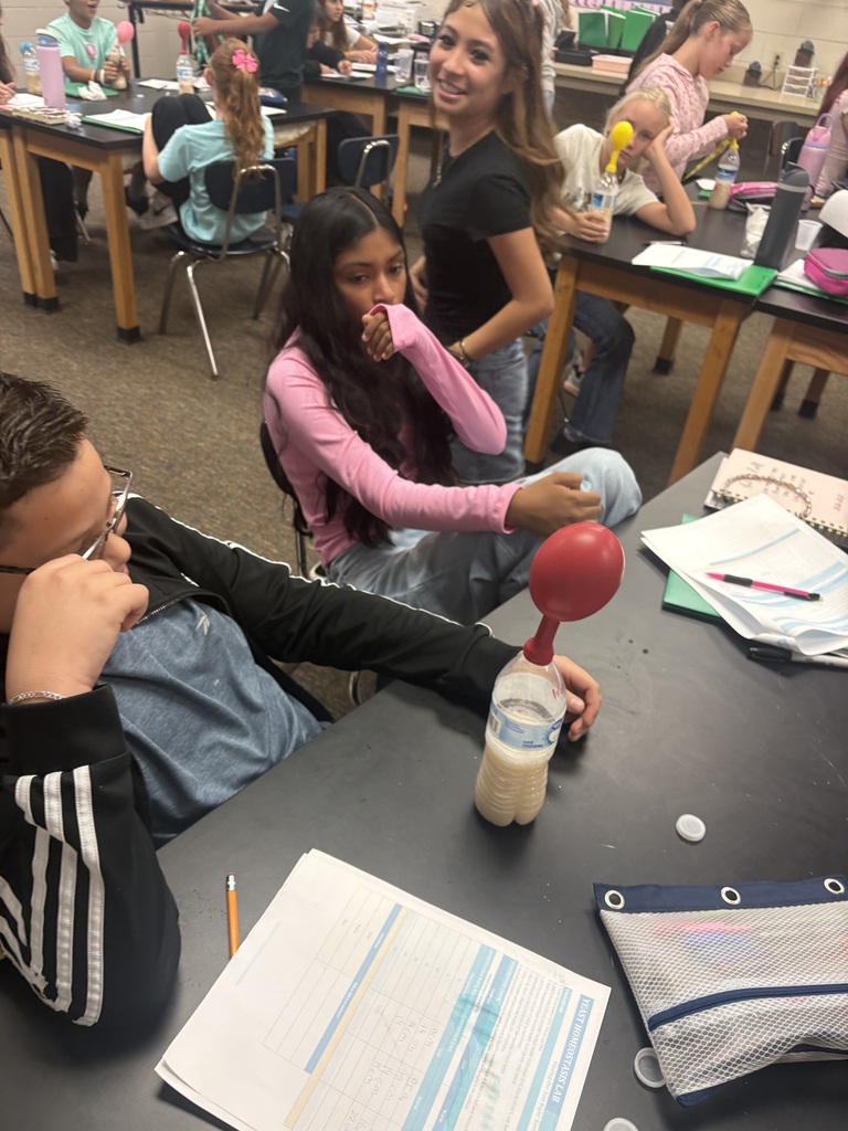 students  conducting a science experiment in class