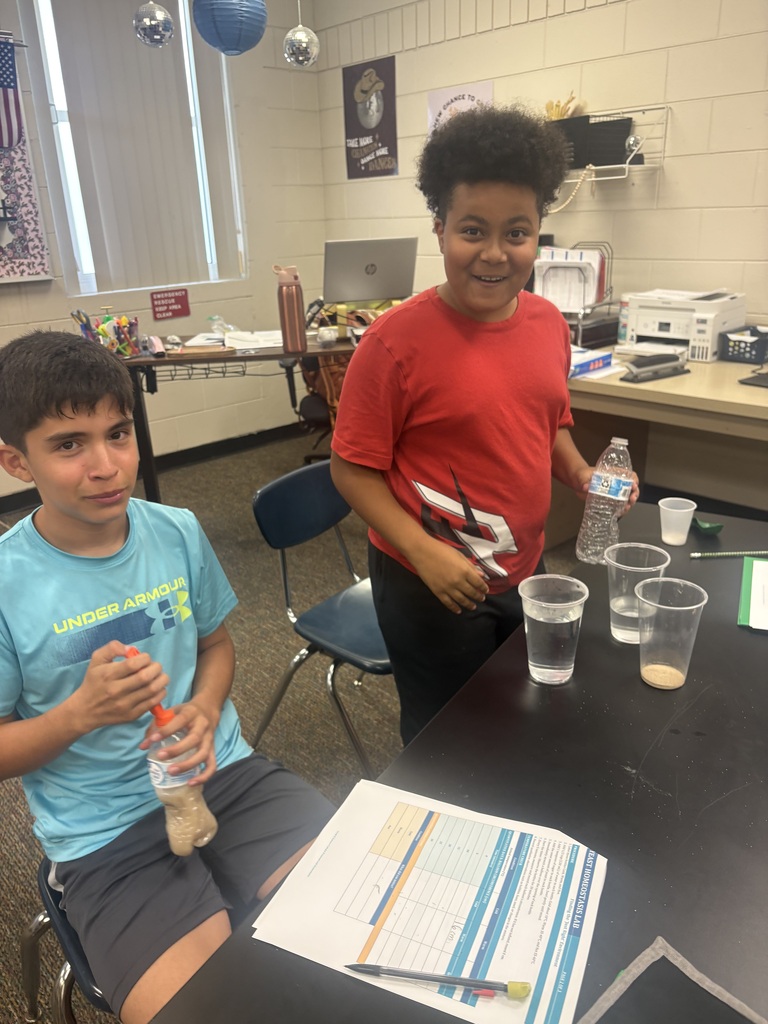 2 male students  conducting a science experiment in class