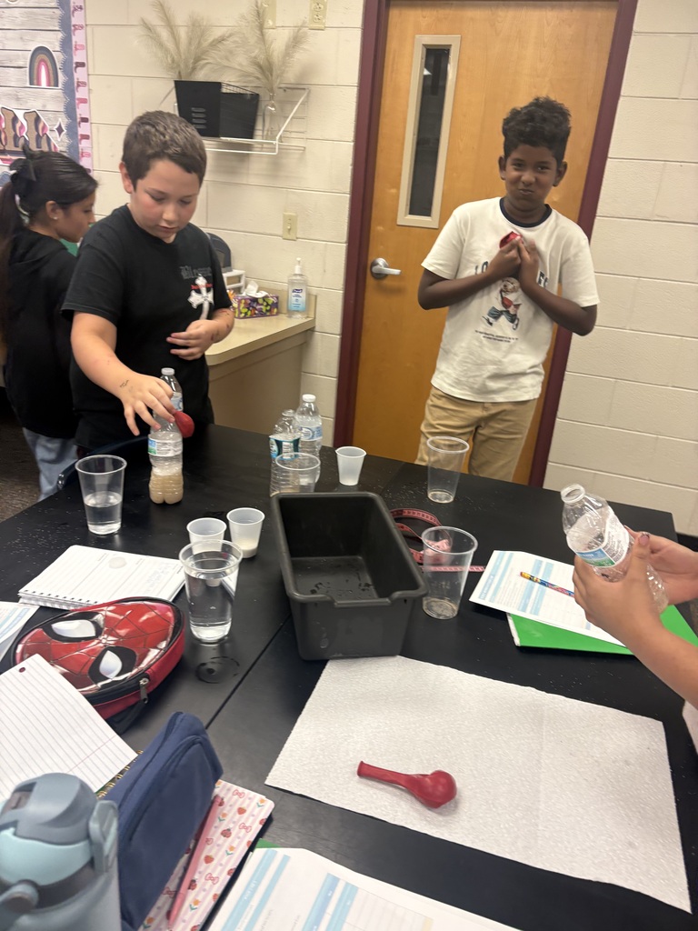 male students conducting a science experiment in class