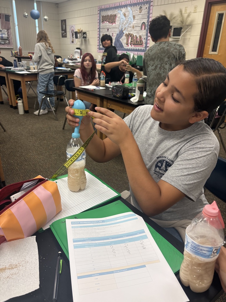 girl student in class doing a science experiment