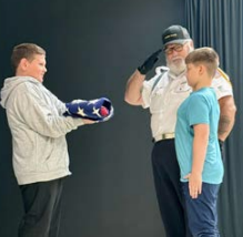 man and two students learnning about the flag