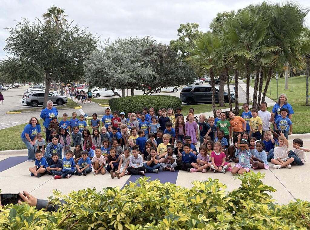 students posing with teachers at Clifford the Big Red Dog play