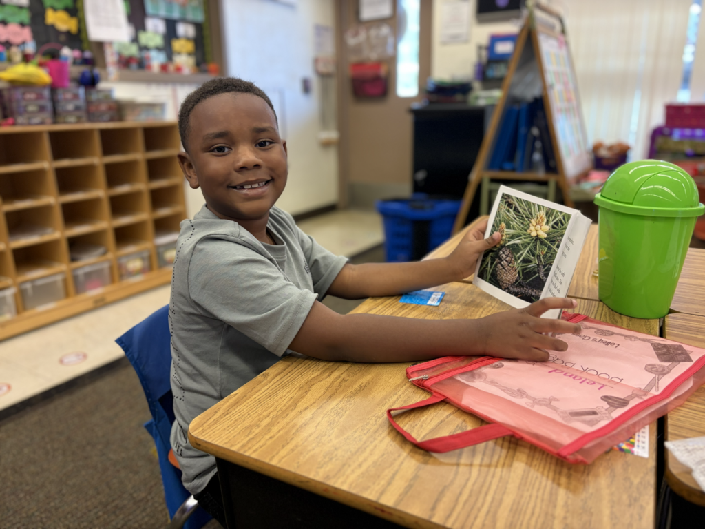 young man reading and smiling