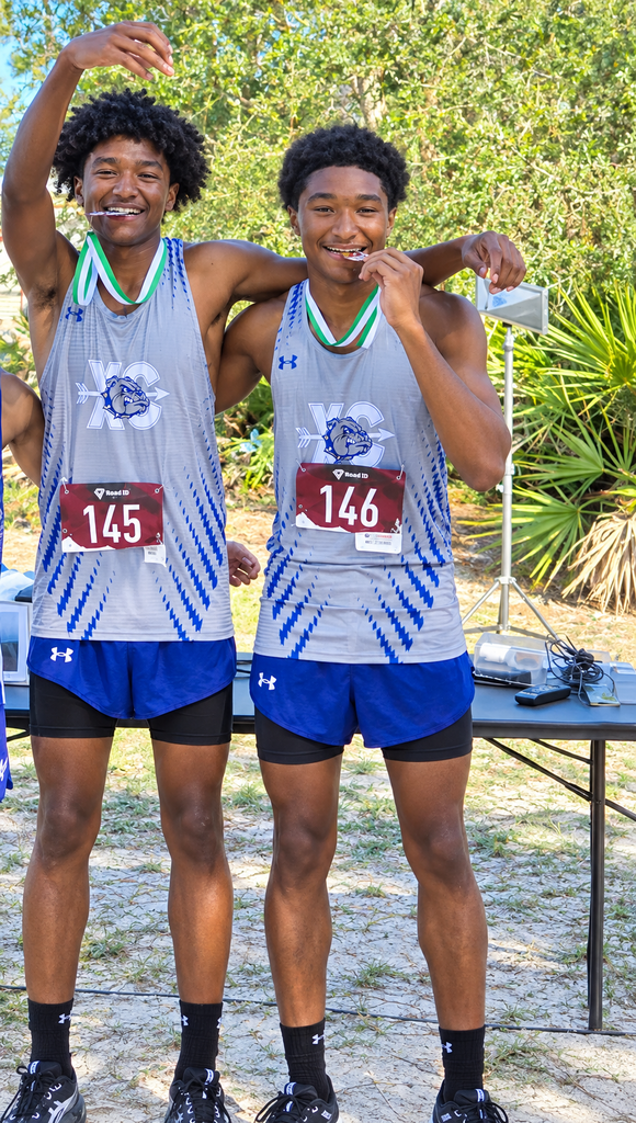 DHS XC two brothers posing with their medals