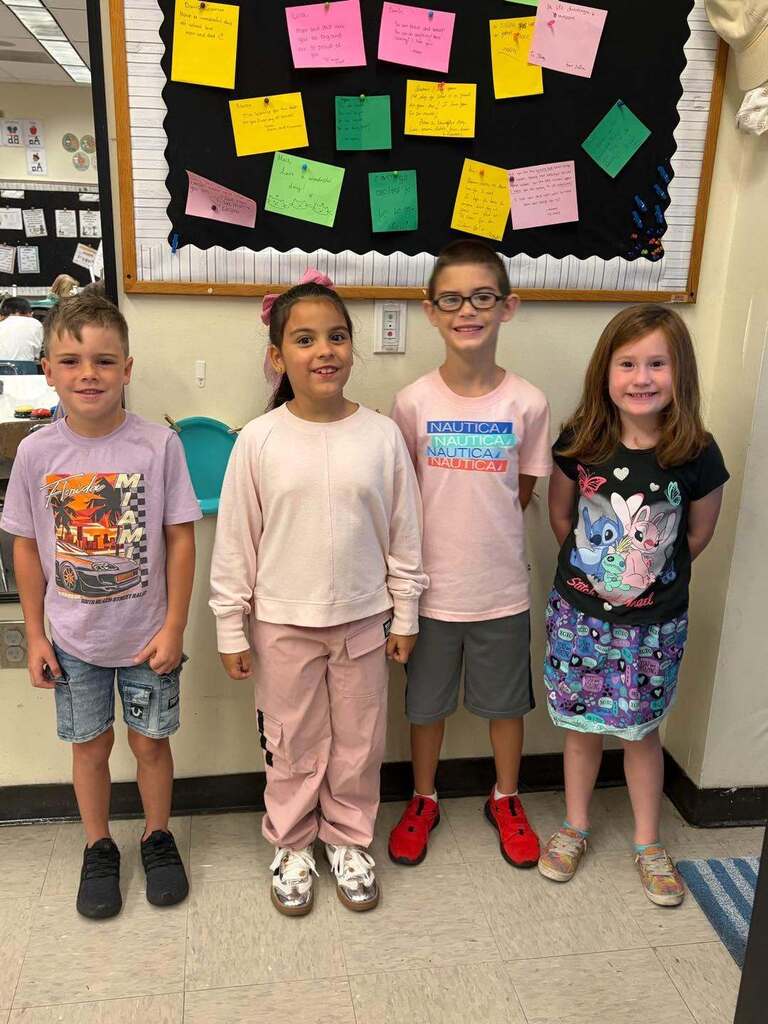 four students smiling for a picture