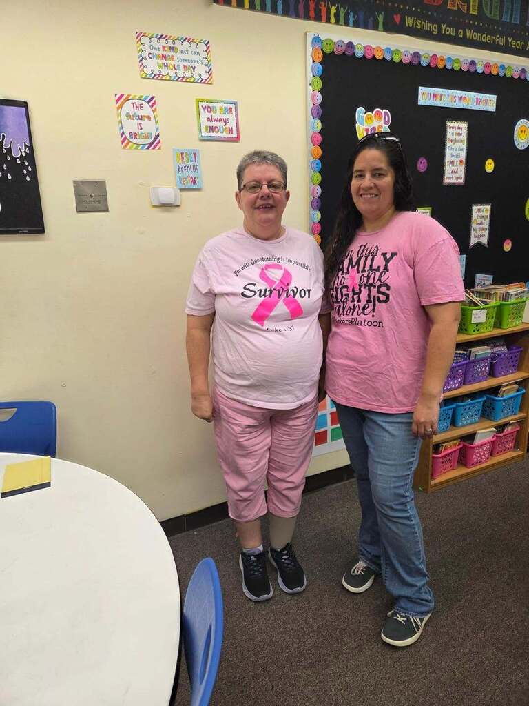 two teacher wearing pink for breast cancer awareness