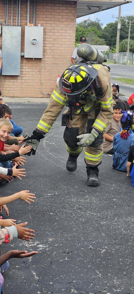 fireman giving students high five