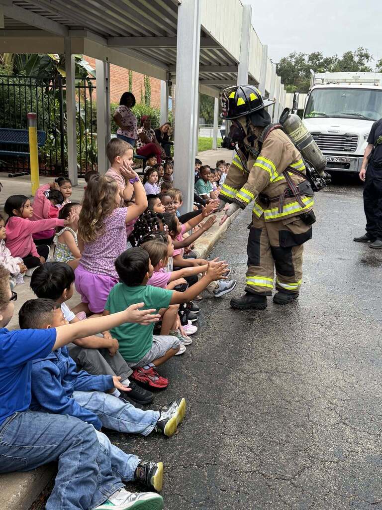 fireman giving students high five