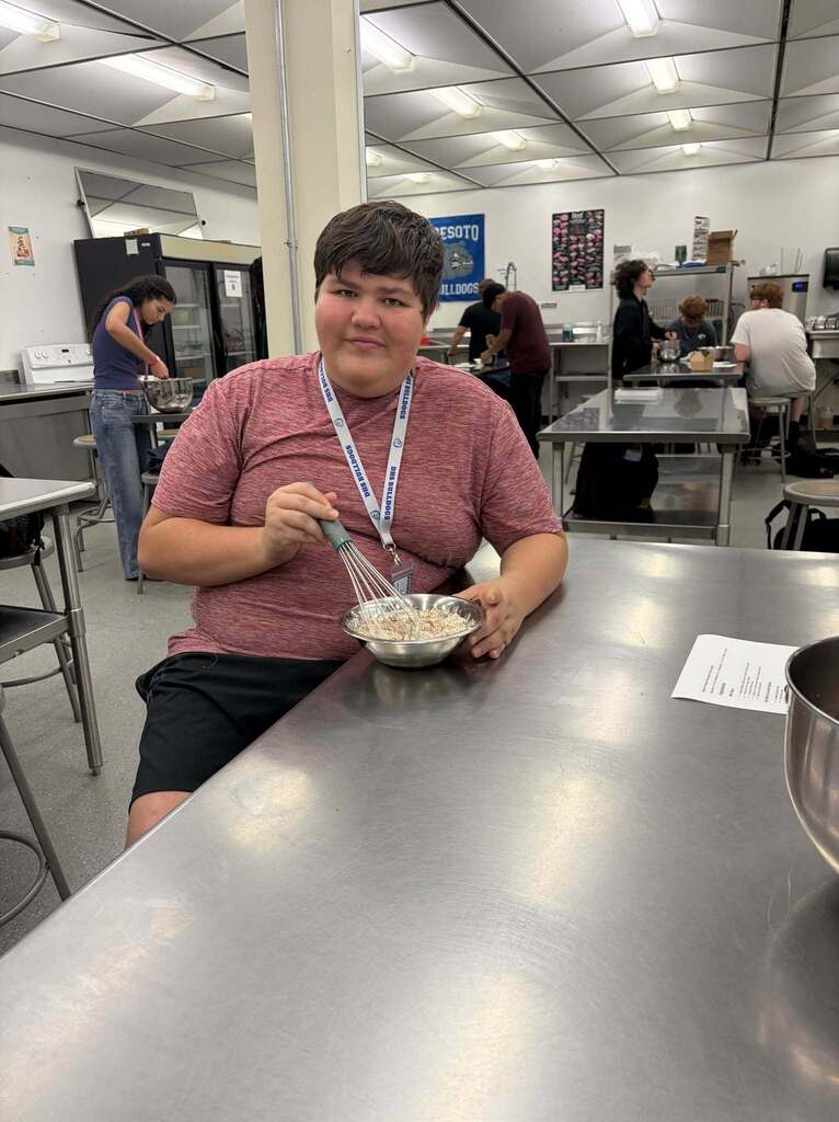 culinary arts student mixing food in a bowl 