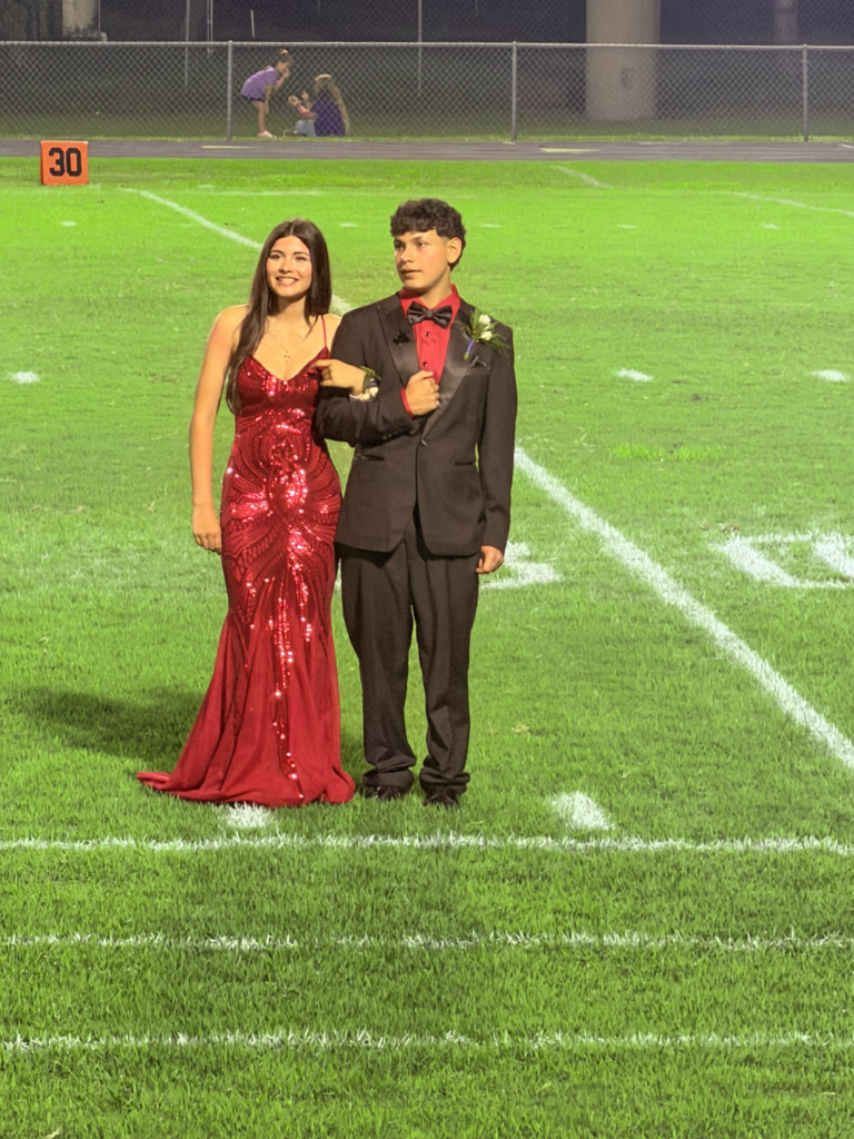 DHS homecoming court girl in red dress and guy in black suit