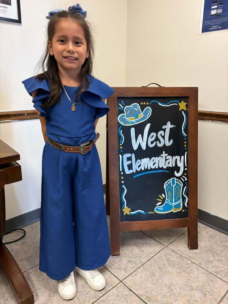 girl wearing blue outfit and smiling