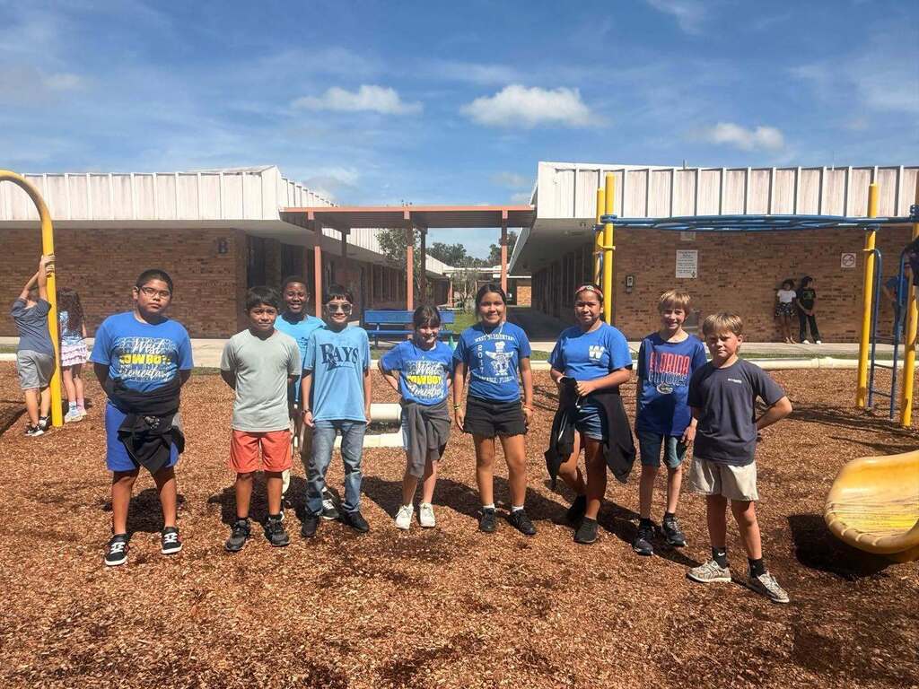 group of students smiling on the playground