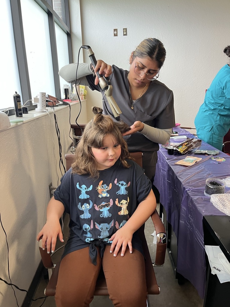 young girl getting her hair curled