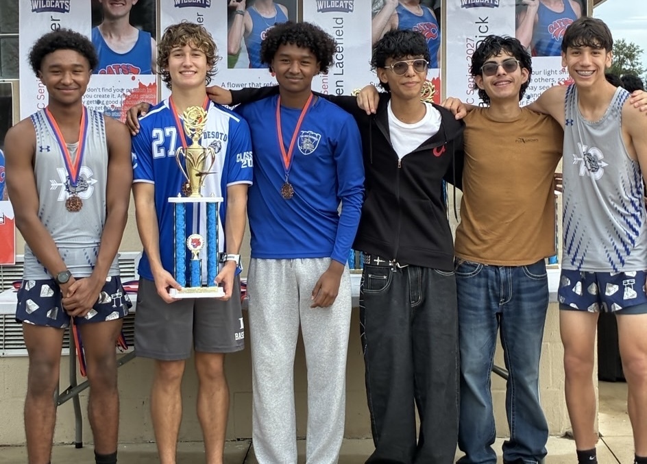 group of XC students posing with trophy and medals