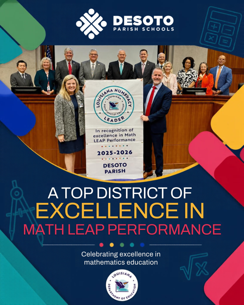 A group of adults in formal attire stand behind a table, where two people hold a sign about top district excellence in math leap performance.