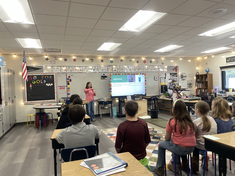 student presenting to other students how trash collects in our oceans and lakes