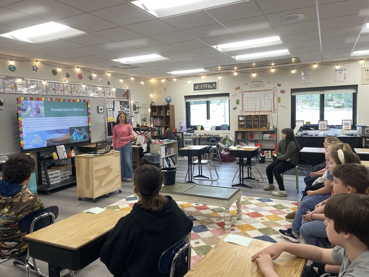 student presenting to a class about keeping the island clean 