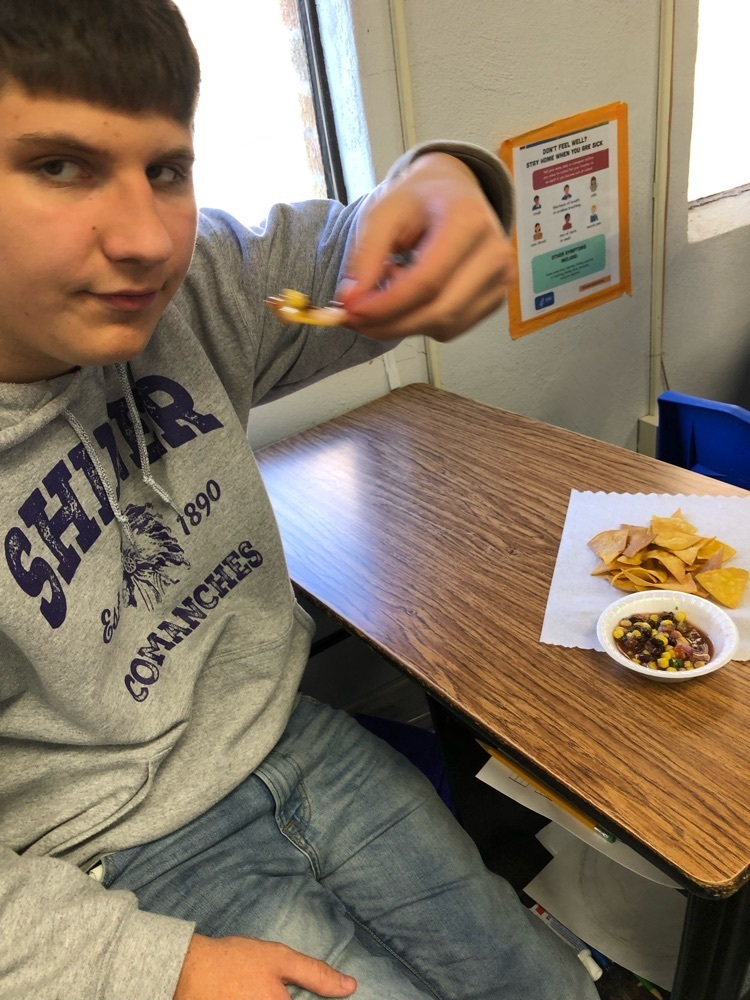 student tasting the recipe