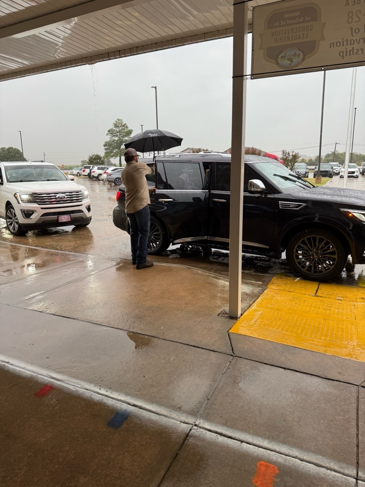 linemen opening car doors for students