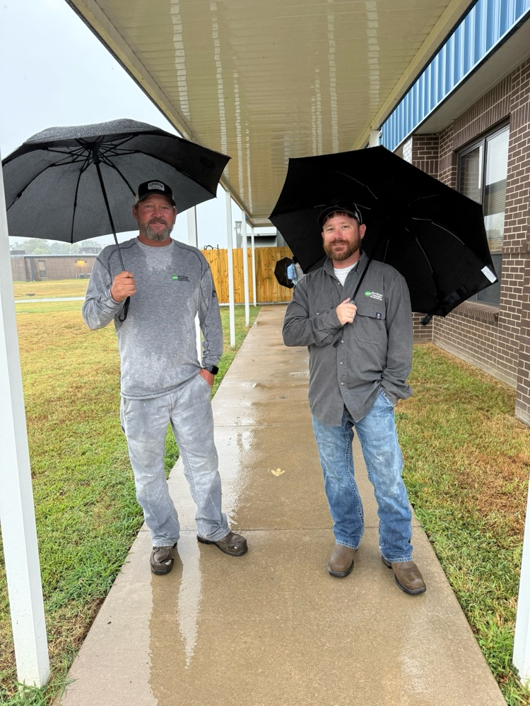 linemen opening car doors for students