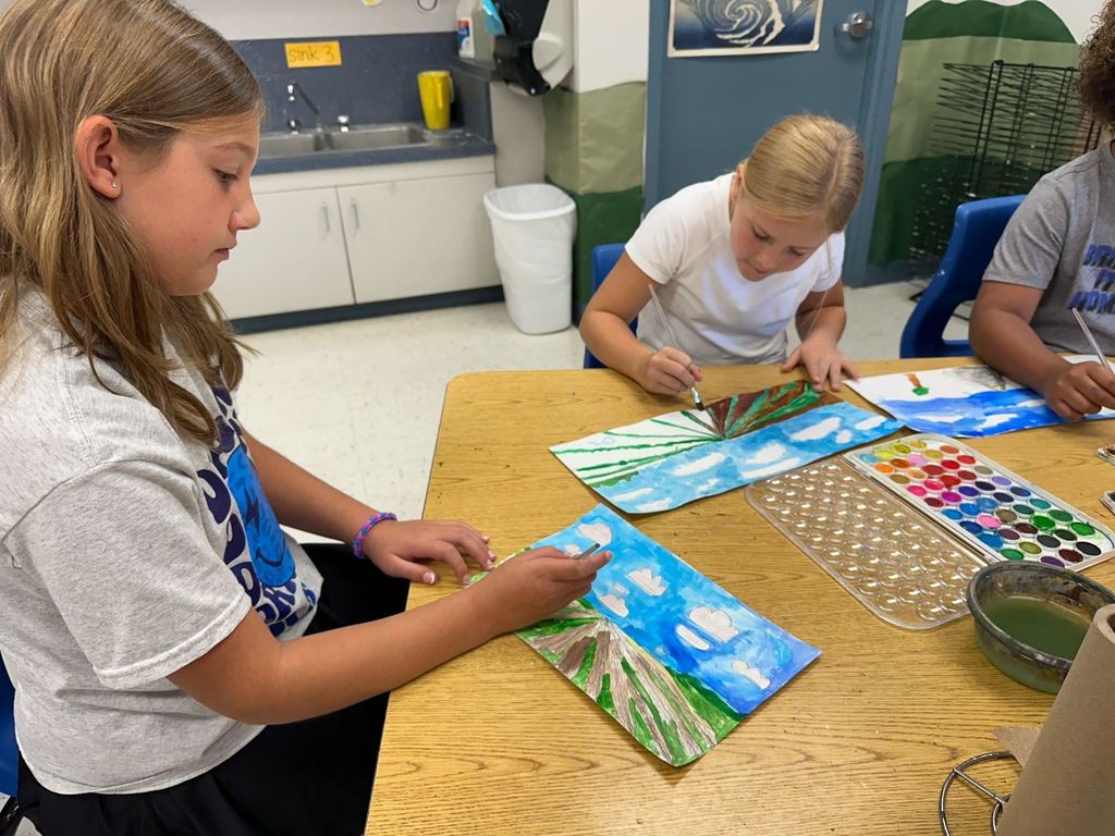 Student painting a landscape