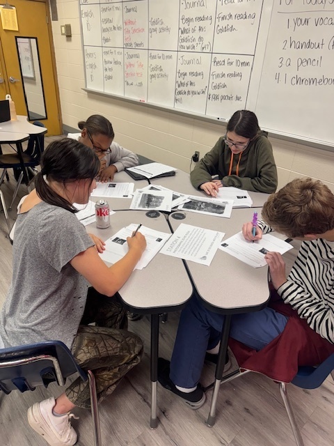 Students traveled to learning stations where they built background knowledge in order to fully understand and appreciate the story we were about to read, which was set in the Middle East. They researched conflict in the region, tried hummus, watched a slam poetry session, and made inferences on quality of life for citizens of that area in that time period.