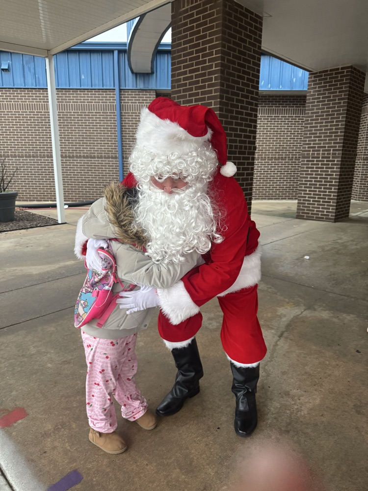 Santa hugging a student