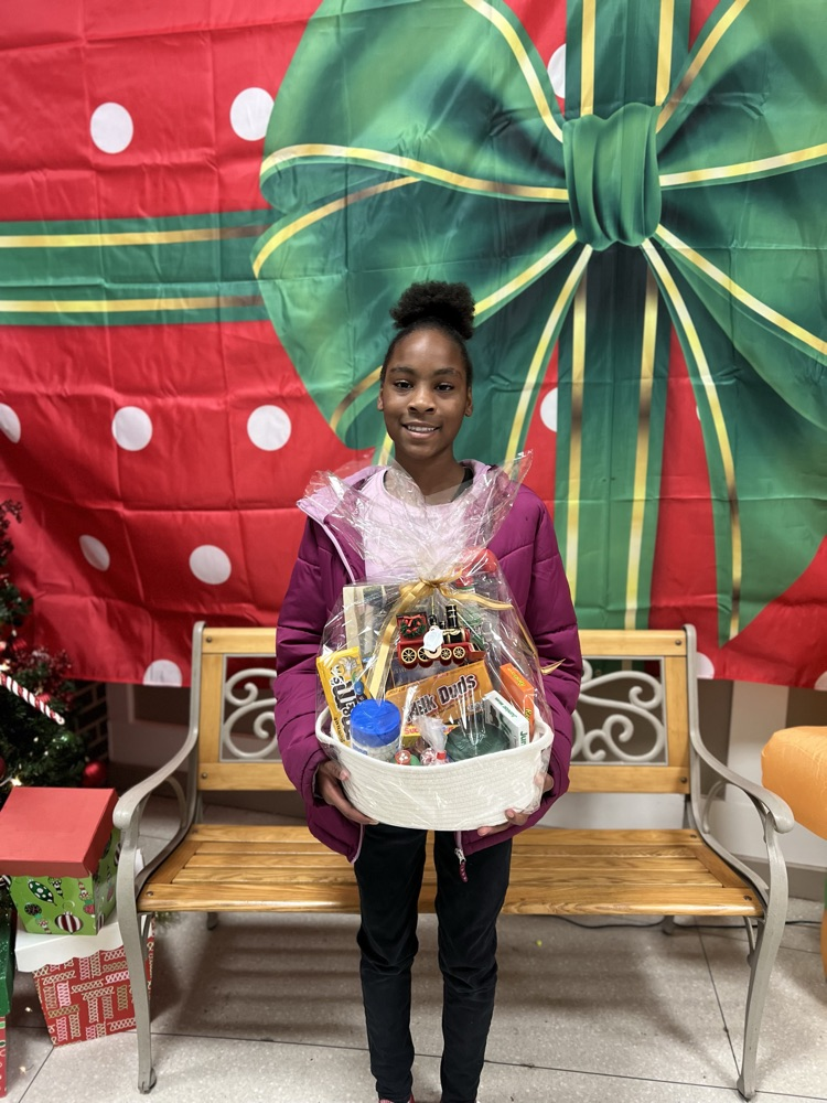 reading challenge winner posing with a gift basket