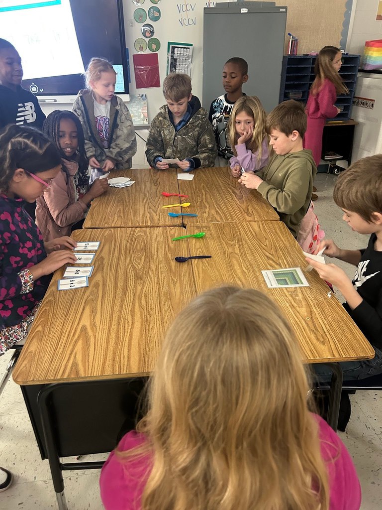 Students Playing the game of spoons with multiplication facts