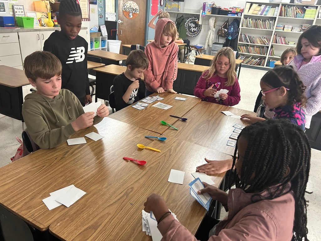 Students Playing the game of spoons with multiplication facts