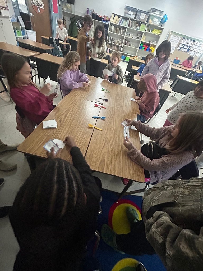 Students Playing the game of spoons with multiplication facts