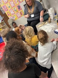 Pre-K Students using various size tools to help complete a task