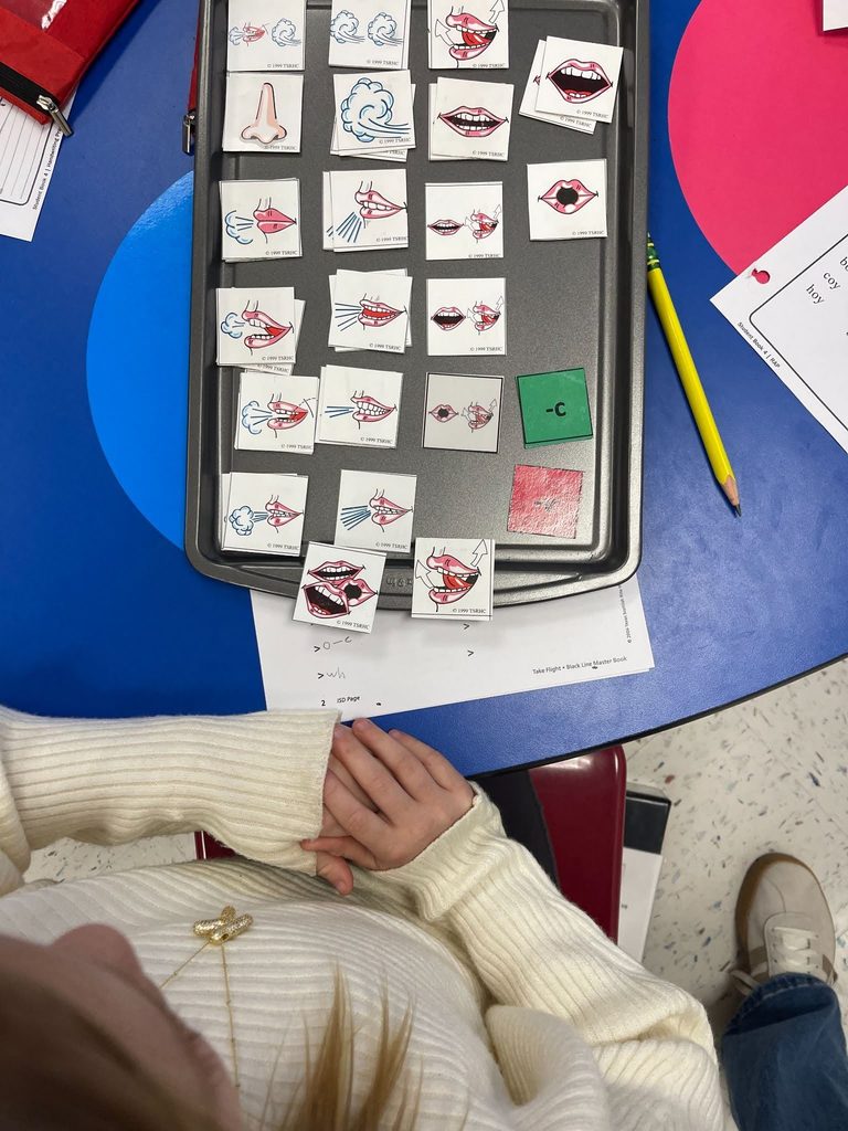 students practicing phonetic awareness with picture tiles