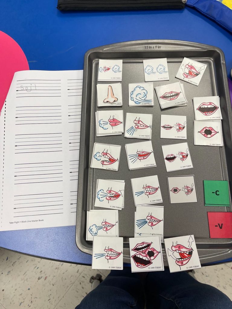 students practicing phonetic awareness with picture tiles